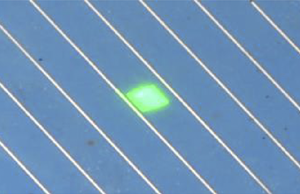 QEXL Solar Cell Quantum Efficiency / IPCE / Spectral Response Measurement System probe beam nested between fingers on a silicon solar cell